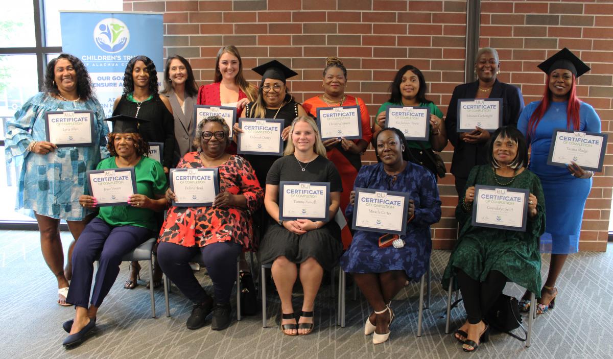 Group of early childhood educators holding certificates