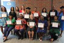 Group of early childhood educators holding certificates